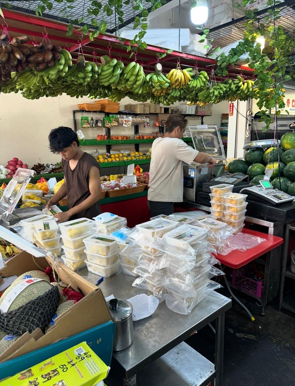 DatoDurian crew packing fresh vacuum-packed durian boxes for corporate orders and events in Singapore